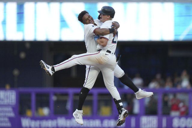 Miami Marlins' Dane Myers, left, and Kyle Stowers, right, celebrate after Stowers hit a walk-off single to score Javier Sanoja during the ninth inning of an opening-day baseball game against the Pittsburgh Pirates, Thursday, March 27, 2025, in Miami. (Photo by Lynne Sladky/AP Photo)