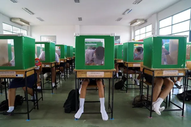Students of Sam Khok school wearing face masks and face shields are seen inside old ballot boxes repurposed into partitions as they attend a class after the Thai government eased isolation measures and introduced social distancing to prevent the spread of the coronavirus disease (COVID-19), as schools nationwide reopen, at Pathum Thani province, Thailand, July 1, 2020. (Photo by Athit Perawongmetha/Reuters)