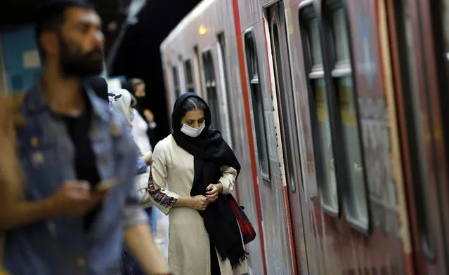An Iranian woman wearing face mask takes a train in a subway station in Tehran, Iran, 10 June 2020. Media reported that according to the last report by the health ministry the spread of novel coronavirus (Covid-19) is growing up while in past 24 hours 2011 new cases have been diagnosed and 84 people died. Iranian health ministry warned people to don't use subways as much as they can. (Photo by Abedin Taherkenareh/EPA/EFE)