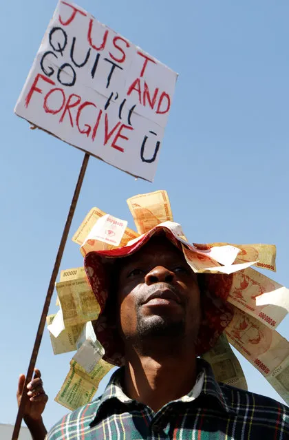 Zimbabweans hold placards during a protest against President Robert Mugabe government's handling of the economy in Harare, Zimbabwe, August 3, 2016. (Photo by Philimon Bulawayo/Reuters)