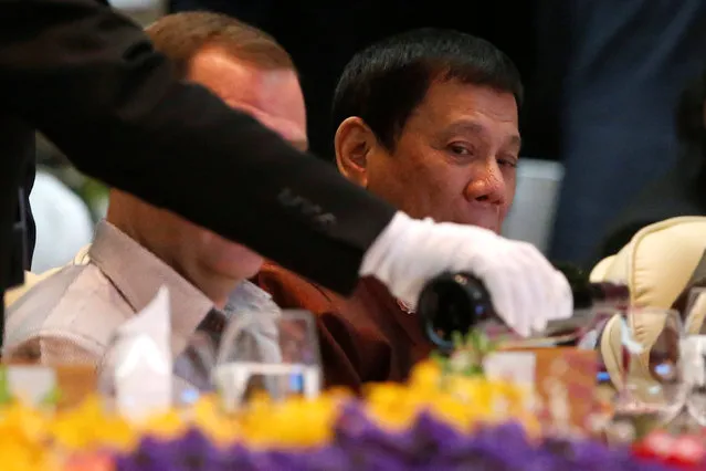 Philippine President Rodrigo Duterte watches as wine is poured at the start of the ASEAN Summit gala dinner in Vientiane, Laos September 7, 2016. (Photo by Jonathan Ernst/Reuters)