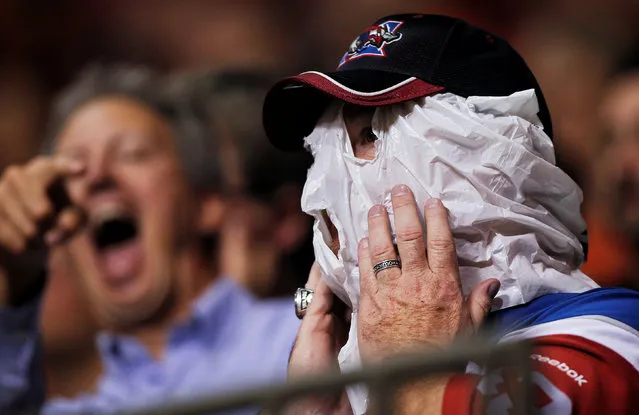 A Montreal Alouettes fan wears a plastic bag over his head while watching his team take on the B.C Lions during the first half of their CFL football game in Vancouver, British Columbia, September 9, 2016. (Photo by Ben Nelms/Reuters)