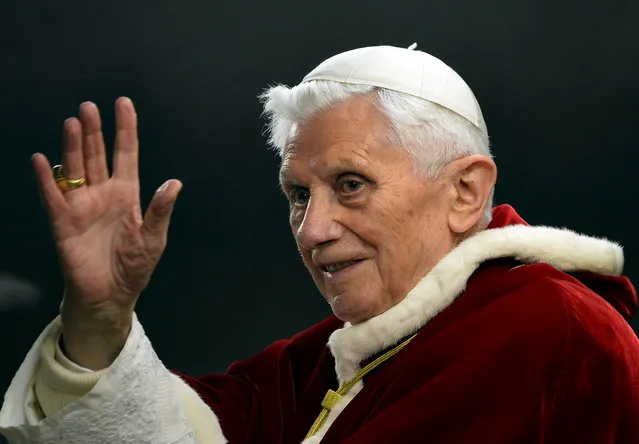 This file picture taken on December 29, 2012, in St.Peter's square at the Vatican shows Pope Benedict XVI saluting as he arrives to the ecumenical christian community of Taize during their European meeting. Pope Benedict XVI on February 11, 2013 announced he will resign on February 28, a Vatican spokesman told AFP, which will make him the first pope to do so in centuries. (Photo by Alberto Pizzoli/AFP Photo)