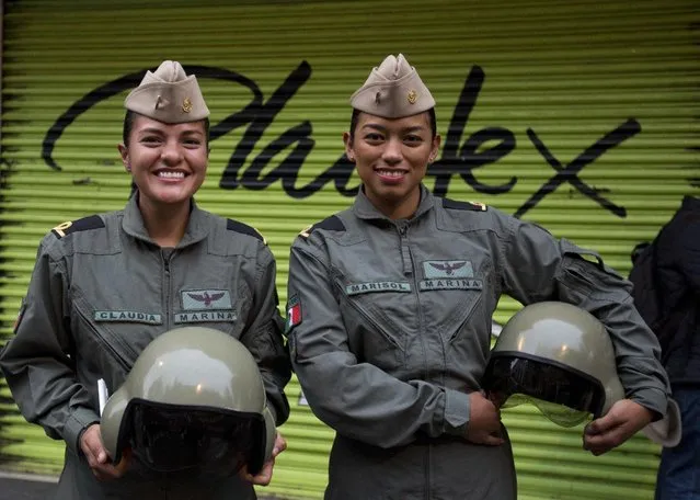 Female sailors stand on a downtown street as they await the start of the annual Independence Day military parade in Mexico City, Friday, September 16, 2016. Mexico is marking the 206th anniversary of its independence from Spain. (Photo by Rebecca Blackwell/AP Photo)