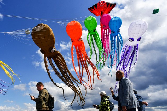 Kites fly in the sky during the Kite Show at the historical complex “Fort Konstantin” in city of Kronstadt outside Saint Petersburg, on June 7, 2025. (Photo by Olga Maltseva/AFP Photo)