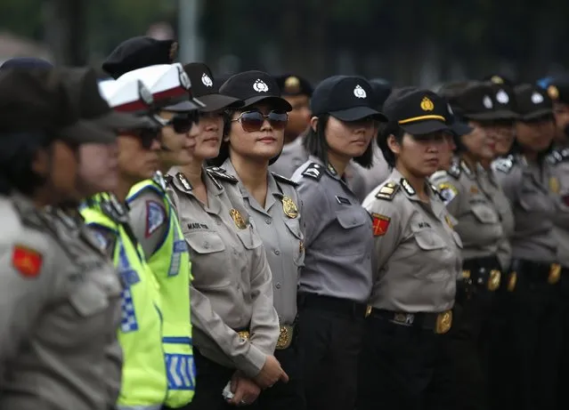 Indonesian police officers stand guard outside the presidential palace during a protest against the recent fuel price hike  in Jakarta November 19, 2014. (Photo by Darren Whiteside/Reuters)