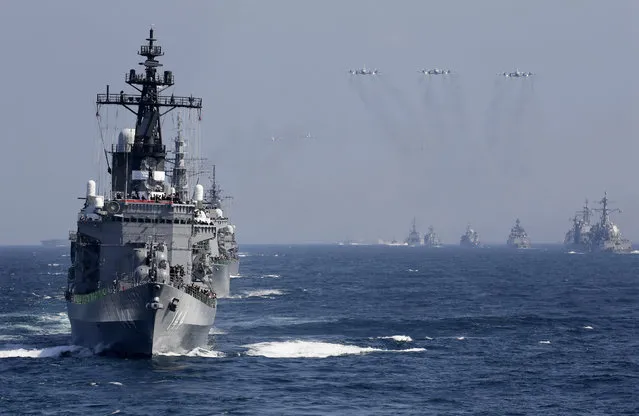 Japanese Maritime Self-Defense Force flagship and destroyer Kurama (L) leads a fleet of navy vessels during a fleet review by Prime Minister Shinzo Abe in Sagami Bay off Odawara, Kanagawa Prefecture, southwest of Tokyo, Japan, 18 October 2015. Sixty-two vessels and 37 aircrafts participated in the review. (Photo by Kimimasa Mayama/EPA)