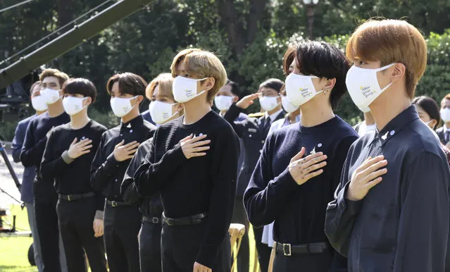South Korean K-pop group BTS members salute to their national flag during a ceremony marking the National Youth Day at the presidential Blue House in Seoul, South Korea, Saturday, September 19, 2020. (Photo by Lee Jin-wook/Yonhap via AP Photo)