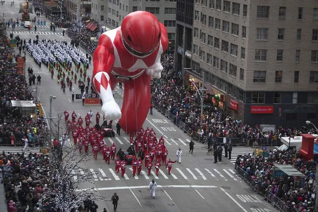 The Red Power Ranger float makes its way down 6th Ave during the Macy's Thanksgiving Day Parade in New York November 27, 2014. (Photo by Carlo Allegri/Reuters)