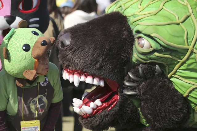 Mascot called “Melon Kuma” strolls at the World Character Summit in Hanyu, Saitama prefecture, north of Tokyo, Saturday, November 22, 2014. More than 400 characters representing local governments in Japan, called “yuruchara”, gathered for the event from all over the country. (Photo by Eugene Hoshiko/AP Photo)