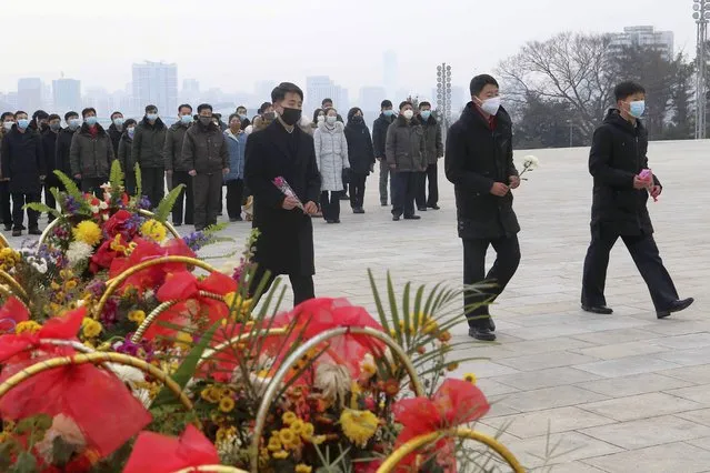 North Koreans visit and pay respect to the statues of late leaders Kim Il Sung and Kim Jong Il on Mansu Hill in Pyongyang, North Korea Sunday, January 22, 2023 on the occasion of the Lunar New Year. (Photo by Jon Chol Jin/AP Photo)