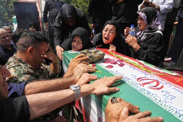 Relatives mourn over the flag-draped coffin of Mahan Setareh, a member of the paramilitary Basij force who was killed in Israeli attacks, during his funeral ceremony in Tehran, Iran, Thursday, June 26, 2025. (Photo by Vahid Salemi/AP Photo)