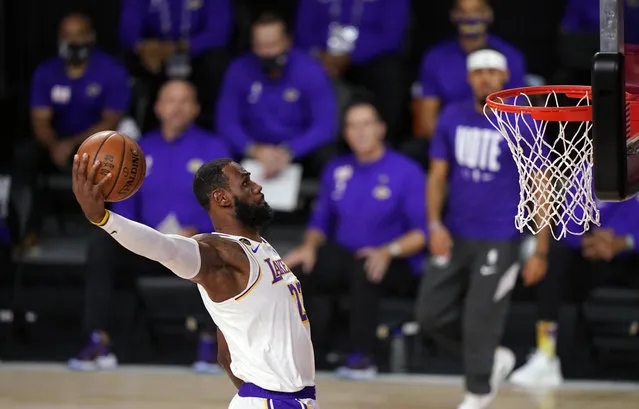 Los Angeles Lakers' LeBron James (23) dunks during the first half in Game 6 of basketball's NBA Finals against the Miami Heat Sunday, Oct. 11, 2020, in Lake Buena Vista, Fla. (Photo by Mark J. Terrill/AP Photo)