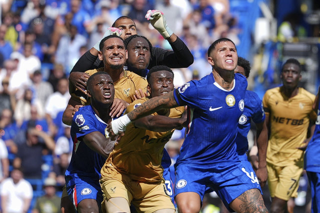 Players jostle for position as they wait for a cross during the English Premier League soccer match between Chelsea and Crystal Palace in London, Sunday, August 17, 2025. (Photo by Dave Shopland/AP Photo)