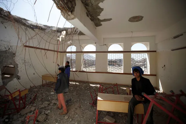 Boys are pictured in a damaged class of their school which was hit by Saudi-led air strikes last year, as schools open this week in Sanaa, the capital of war-torn Yemen October 5, 2016. (Photo by Khaled Abdullah/Reuters)