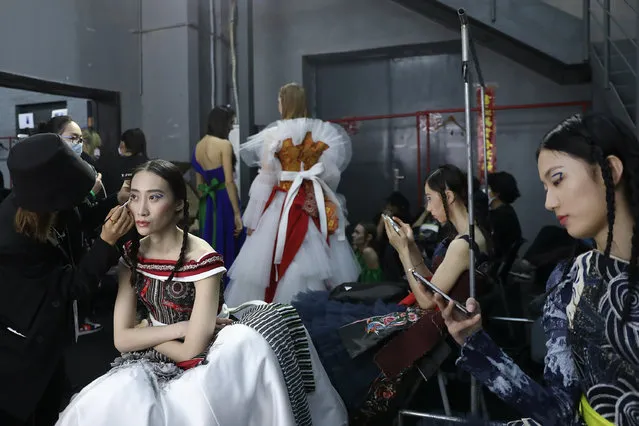 Models prepares backstage before during Dong Xiang Female Embroider collection show by Chinese designer Zhang Zhaoda on day two of China Fashion Week at 751D.PARK on October 25, 2020 in Beijing, China. (Photo by Lintao Zhang/Getty Images)