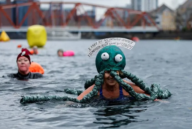 Swimmers wearing fancy dress costumes take to the water at a New Year's Day event in Manchester, Britain, January 1, 2022. (Photo by Jason Cairnduff/Reuters)