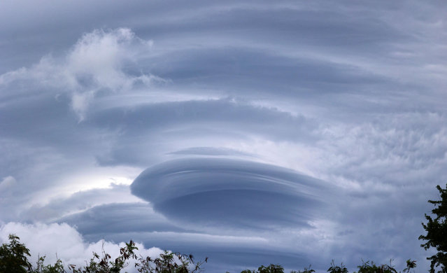 Lenticular clouds are pictured on January 14, 2024 in La Possession as authorities on France's Indian Ocean Reunion Island urged residents to stock up on food and water ahead of a tropical storm that risks strengthening to a cyclone before it hits later tonight. The storm, dubbed Belal, could hammer the island with winds of up to 150 km/h (90 mph) if it only passes nearby, according to the Meteo France weather service. (Photo by Richard Bouhet/AFP Photo)