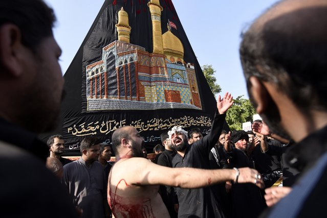 Pakistani Shiite Muslims attend a mourning procession a day ahead of the commemoration of Ashura, in Islamabad, Pakistan, 11 October 2016. (Photo by T. Mughal/EPA)