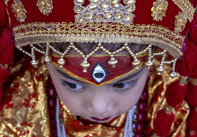 A Nepalese girl wears traditional attire as she attends Kumari Puja, a baby girls mass worship ceremony at Hanuman Dhoka Durbar Square in Kathmandu, Nepal, 05 September 2025. More than 300 hundred girls under the age of seven from across the country gathered for the mass worship. Performing Kumari Puja for three continuous years is believed to protect the girls from diseases throughout their entire life. The Kumari is regarded as incarnation of a Hindu goddess since the 16th century. (Photo by Narendra Shrestha/EPA)