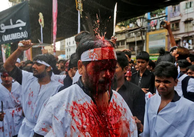 A Shi'ite muslim mourner is sprayed with rose water after he flagellated himself during a Muharram procession to mark Ashura in Mumbai, India, October 12, 2016. (Photo by Shailesh Andrade/Reuters)