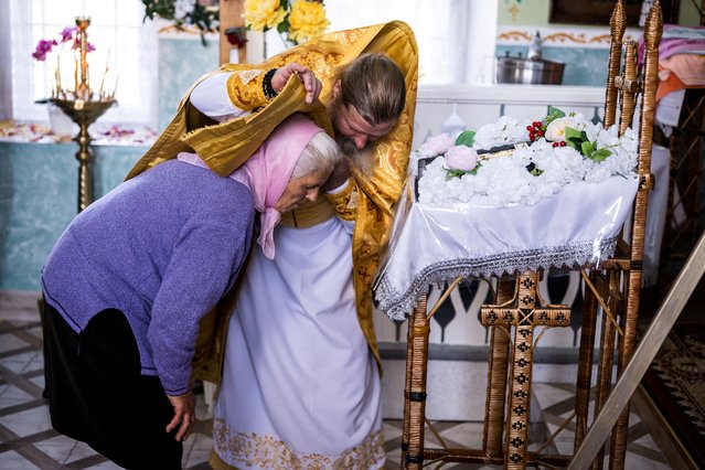 A woman confesses at Archbishop Marchel's Mass at a church in Slobozia-Magura, Moldova, on September 6, 2025. (Photo by Marton Monus/Reuters)