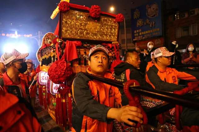 Pilgrims carry god statues inside a sedan chair to celebrate the 165th birthday of Bangka Qingshan Temple in Taipei, Taiwan, December 6, 2020. (Photo by Ann Wang/Reuters)