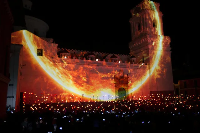 Thousands of pedestrians gather downtown for a lighting and chromalithe exhibition on a catholic church, as part of the UN Habitat III conference in Quito, Ecuador October 18, 2016. (Photo by Guillermo Granja/Reuters)