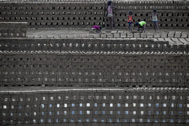 Indian children work in a brick kiln on the outskirts of Gauhati, northeastern Assam state, India, Monday, November 9, 2020. (Photo by Anupam Nath/AP Photo)