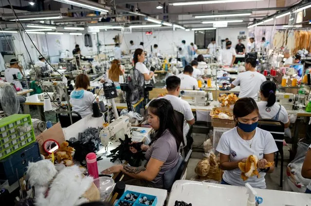 Workers make customized pet plushies and clothing, at the Pampanga Teddy Bear Factory, in Angeles City, Pampanga province, Philippines on March 10, 2023. (Photo by Lisa Marie David/Reuters)