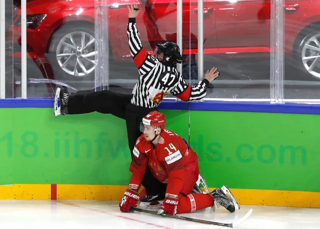 Yevgeny Lisovets of Belarus crashes into a referee during the 2018 IIHF Men' s Ice Hockey World Championship match between Sweden and Belarus on May 4, 2018 in Copenhagen, Denmark. (Photo by Grigory Dukor/Reuters)