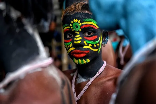 A young Hindu devotee seen with his face painted as part of traditional practices during the annual Gajan Festival in Bardhhaman, India on April 12, 2023. (Photo by Avishek Das/SOPA Images/Rex Features/Shutterstock)