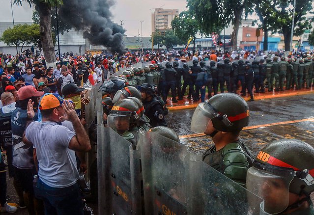 Demonstrators in Puerto La Cruz, Venezuela, confront police during a protest against the government of Venezuelan President Nicolas Maduro on Monday, July 29, 2024. Both Maduro and his political opponent claimed victory in the country’s election on Monday, a vote that was marked by accusations of fraud and counting irregularities. (Phoot by Carlos Landaeta/AFP Photo)