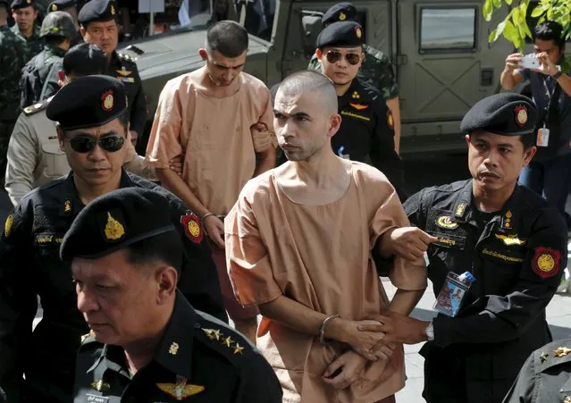 Suspects of the August 17 Bangkok blast, Bilal Mohammed (also known as Adem Karadag) and Yusufu Mieraili are escorted by soldiers and prison officers as they arrive at the military court in Bangkok, Thailand, November 24, 2015. A Thai military court has indicted the two men accused of carrying out a Bangkok bomb attack that killed 20 people including 14 foreigners, making it the deadliest such incident in Thai history. A lawyer for one of the men said a Bangkok military court brought ten charges against the pair, including premeditated murder, illegal possession of weapons and murder. (Photo by Chaiwat Subprasom/Reuters)