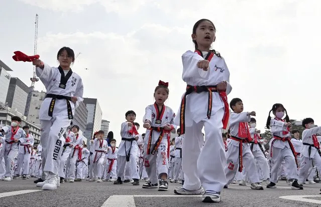 Taekwondo practitioners perform during a demonstration event at Gwanghwamun Square in Seoul on March 25, 2023. The event, which involved more than 10,000 participants including children, is expected to set a new Guinness world record with their simultaneous taekwondo display. (Photo by Jung Yeon-je/AFP Photo)