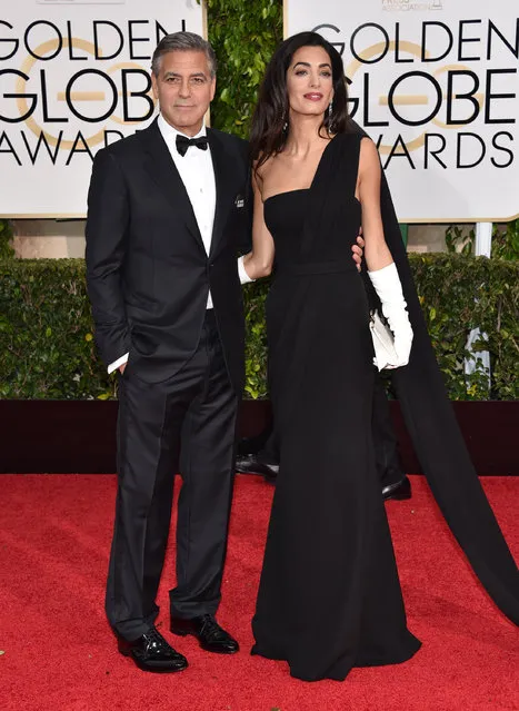 George Clooney, left, and Amal Clooney arrive at the 72nd annual Golden Globe Awards at the Beverly Hilton Hotel on Sunday, January 11, 2015, in Beverly Hills, Calif. George is wearing a “Je suis Charlie” button. (Photo by John Shearer/Invision/AP Photo)