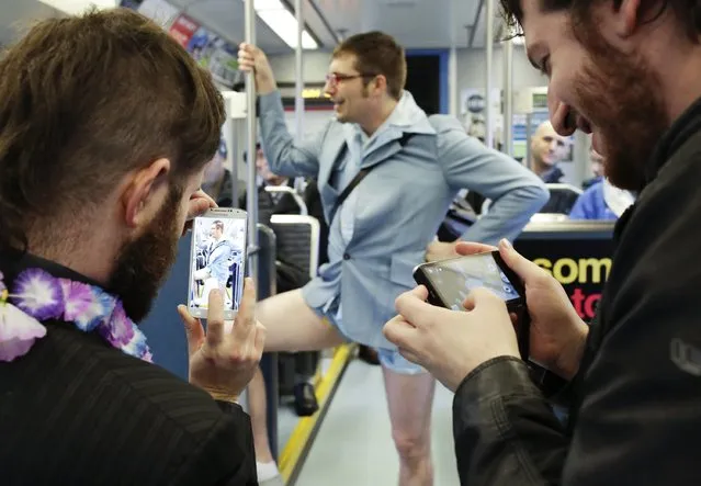 Luke Walker of Seattle poses for photos during the annual No Pants Light Rail Ride organized by the Emerald City Improv group in Seattle, Washington January 11, 2015. (Photo by Jason Redmond/Reuters)