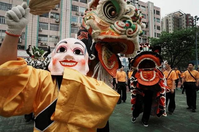Participants perform lion dance during a parade celebrating Tin Hau festival at Yuen Long district, in Hong Kong, China on May 12, 2023. (Photo by Lam Yik/Reuters)