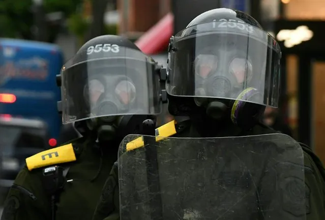 Riot police wearing gas masks look on during an anti-G7 demonstration in Quebec City, Quebec, June 7, 2018, on the eve of the leaders' summit. (Photo by Martin Ouellet-Diotte/AFP Photo)