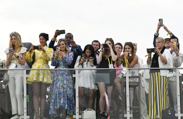 Race fans take snapshots as National Treasure (1) with jockey John Velazquez on board enters the winners circle after they won the 148th running of the Preakness Stakes at Pimlico Race Course on May 20, 2023. (Photo by Jonathan Newton/The Washington Post)