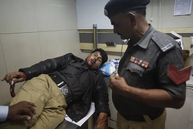 A policeman who suffered wounds from stone pelting during a protest against satirical French weekly Charlie Hebdo receives medical attention at a hospital in Karachi January 16, 2015. (Photo by Athar Hussain/Reuters)