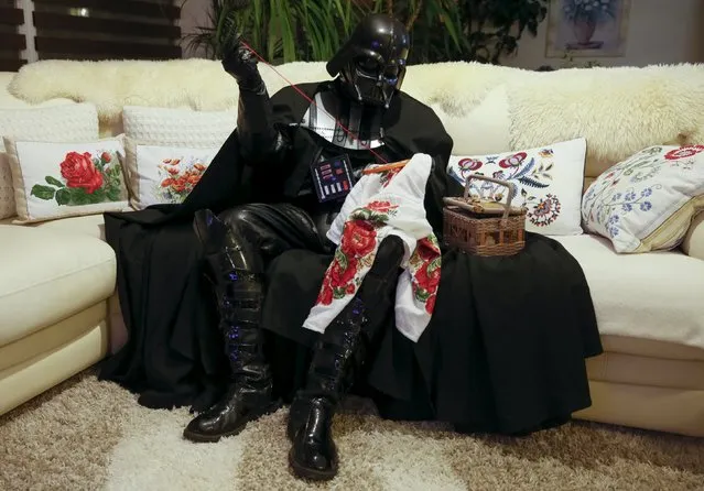 Darth Mykolaiovych Vader, who is dressed as the 'Star Wars' character Darth Vader, poses for a picture as he does embroidery at his apartments in Odessa, Ukraine, December 2, 2015. (Photo by Valentyn Ogirenko/Reuters)