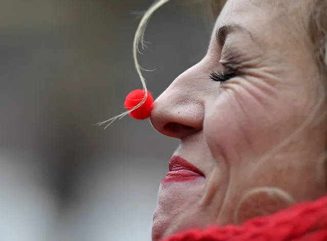 A reveller with a tiny red nose celebrates the start of the carnival season in the streets of Cologne, Germany, on Friday, November 11, 2016. (Photo by Martin Meissner/AP Photo)