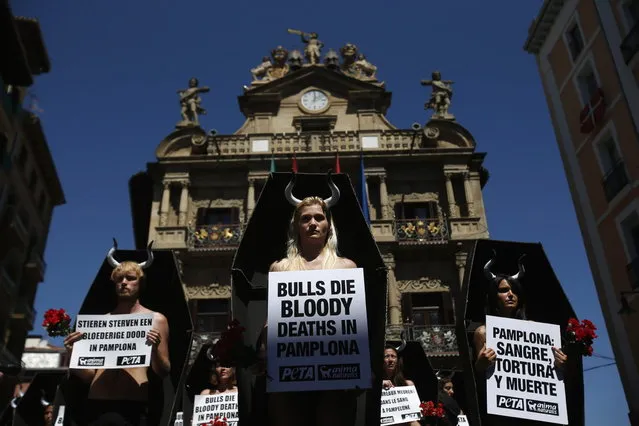 Animal rights protesters stand inside cardboard coffins during a demonstration calling for the abolition of bull runs and bullfights, a day before the start of the famous running of the bulls San Fermin festival, in Pamplona July 5, 2013. Some 48 animal rights activists, representing the number of tortured or killed bulls in the San Fermin festival, protested outside Pamplona's Town Hall, according to the activists' spokesperson. The annual week-long fiesta starts July 6, with the first bull run taking place the morning of July 7.  REUTERS/Susana Vera (SPAIN - Tags: CIVIL UNREST ANIMALS POLITICS)
