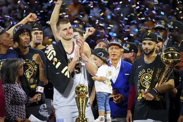 Denver Nuggets center Nikola Jokic, center left, celebrates with teammates after the team won the NBA Championship with a victory over the Miami Heat in Game 5 of basketball's NBA Finals, Monday, June 12, 2023, in Denver. (Photo by Jack Dempsey/AP Photo)