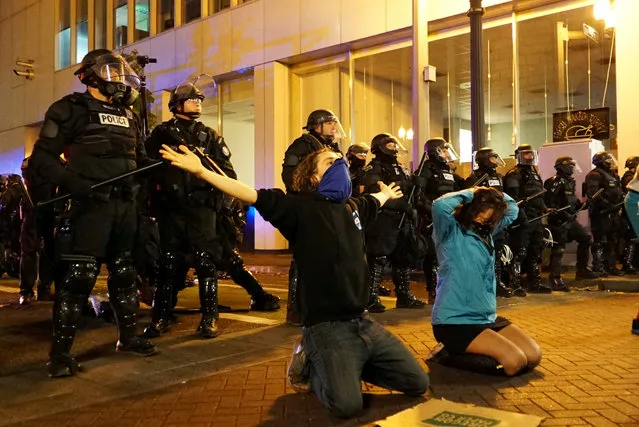 Demonstrators gesture in front of the police during a protest against the election of Republican Donald Trump as President of the United States in Portland, Oregon, U.S. November 11, 2016. (Photo by Cole Howard/Reuters)
