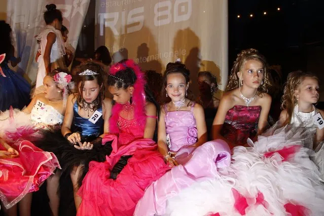Contestants wait for the announcement of the results during the “mini-miss” beauty contest in Bobigny, Paris suburb, September 22, 2012. The competition is open for girls aged 7 to 12. (Photo by Benoit Tessier/Reuters)