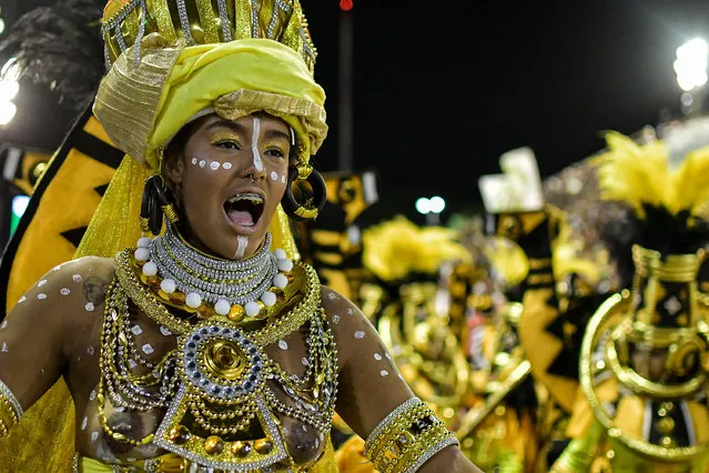 Members of the Escola de Samba Mocidade during a presentation in the parade of the Special Group of Carnival in Rio de Janeiro on Avenida Marques de Sapucai, Sambadrome do Rio de Janeiro on April 23, 2021. The Carnival parades that take place in February were postponed to this month of April due to the high number of cases caused during the pandemic caused by COVID-19. (Photo by Thiago Ribeiro/AGIF via AFP Photo)