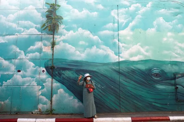 A woman gives a three-finger salute during a rally against the military coup in Yangon, Myanmar, February 10, 2021. (Photo by Reuters/Stringer)