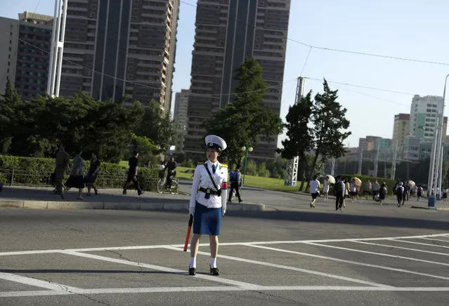 A traffic police officer stands in the middle of a road during morning rush hour in Pyongyang, North Korea, Friday, June 22, 2018. (Photo by Dita Alangkara/AP Photo)
